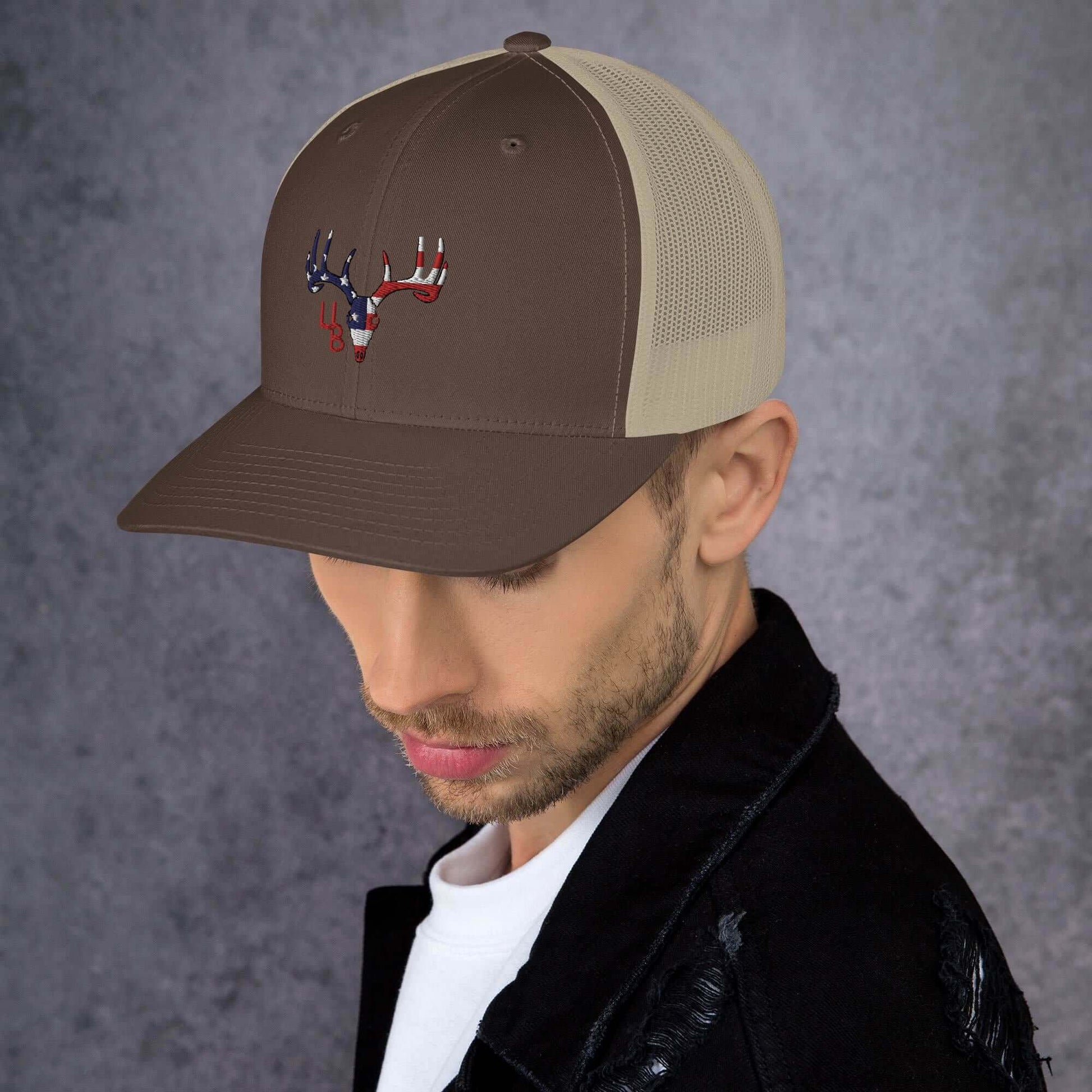 4B Americana Deer Trucker Hat This six-panel trucker cap with a mesh back will be a comfy and classic choice for a perfect day in the sun. • 60% cotton, 40% polyester • Mid-profile cap with a low-profile embroidery area • Structured, six-panel cap • 3.5″