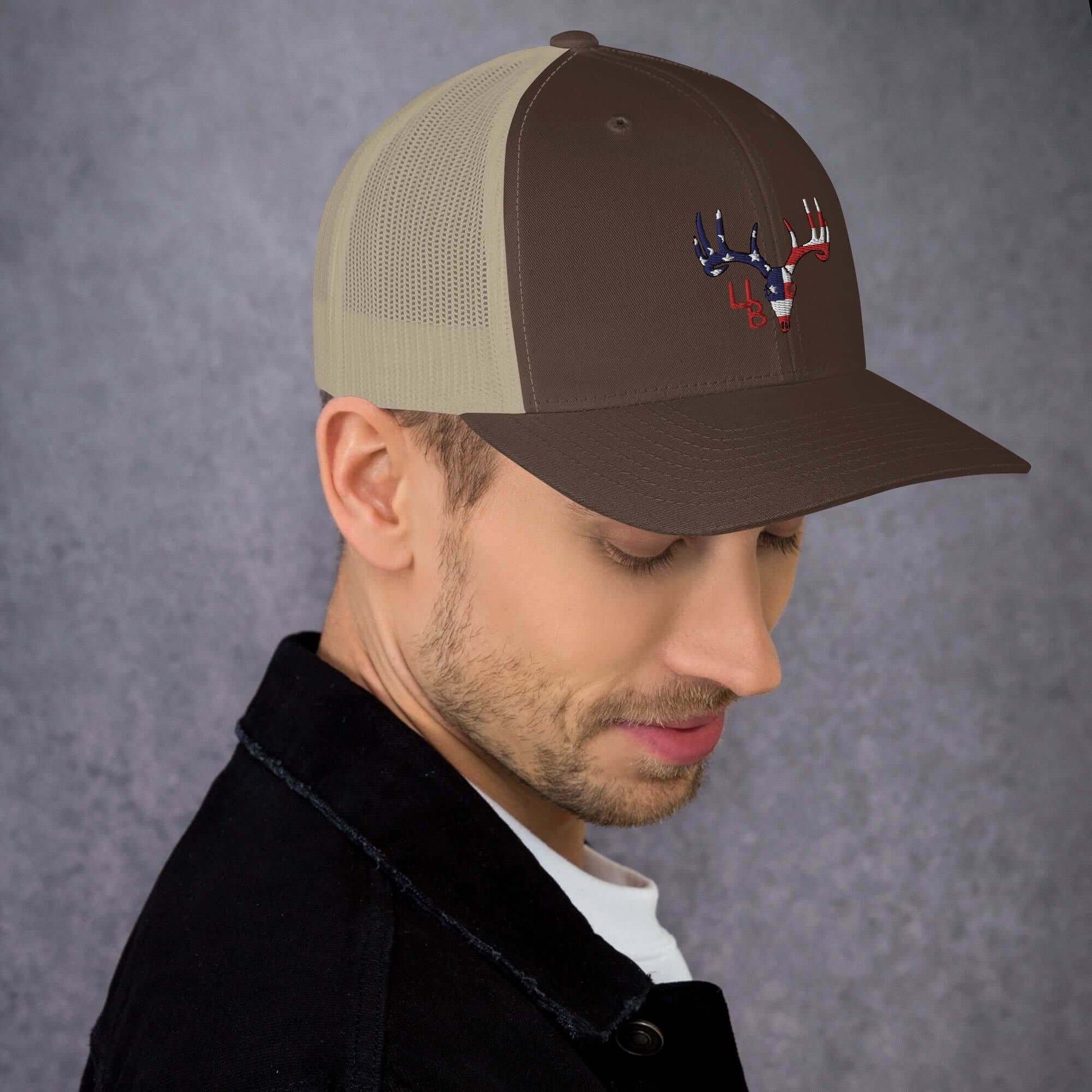 4B Americana Deer Trucker Hat This six-panel trucker cap with a mesh back will be a comfy and classic choice for a perfect day in the sun. • 60% cotton, 40% polyester • Mid-profile cap with a low-profile embroidery area • Structured, six-panel cap • 3.5″