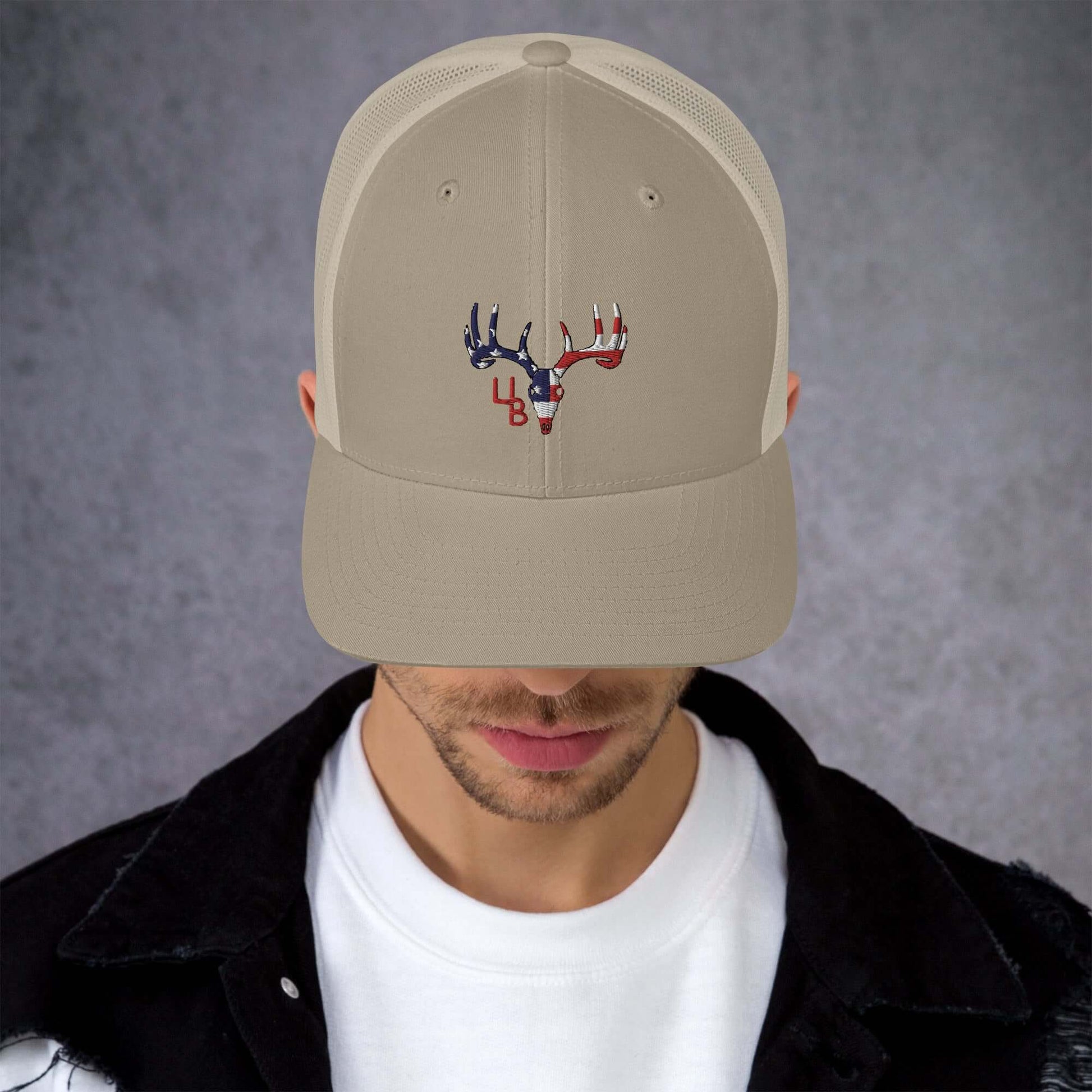 4B Americana Deer Trucker Hat This six-panel trucker cap with a mesh back will be a comfy and classic choice for a perfect day in the sun. • 60% cotton, 40% polyester • Mid-profile cap with a low-profile embroidery area • Structured, six-panel cap • 3.5″