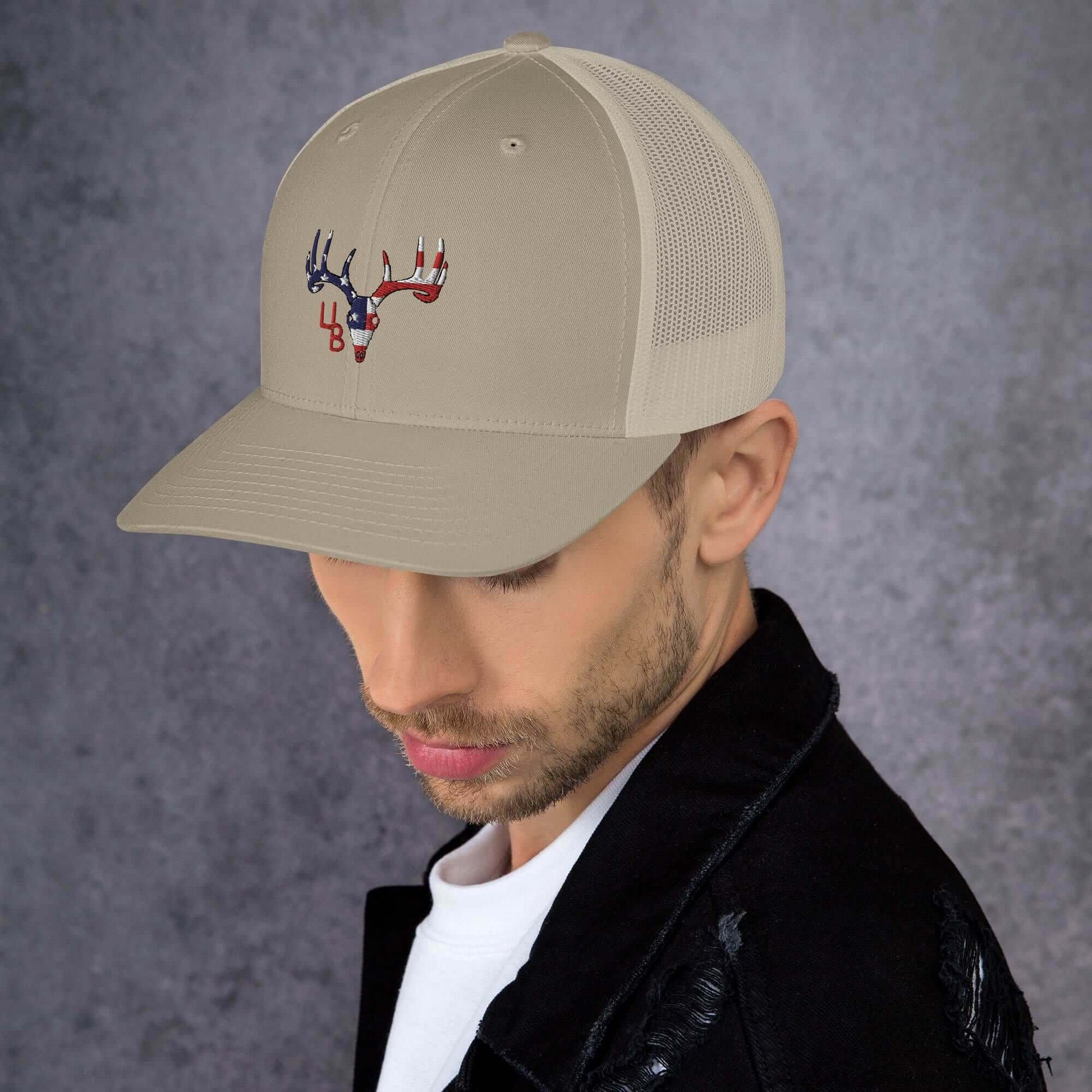 4B Americana Deer Trucker Hat This six-panel trucker cap with a mesh back will be a comfy and classic choice for a perfect day in the sun. • 60% cotton, 40% polyester • Mid-profile cap with a low-profile embroidery area • Structured, six-panel cap • 3.5″