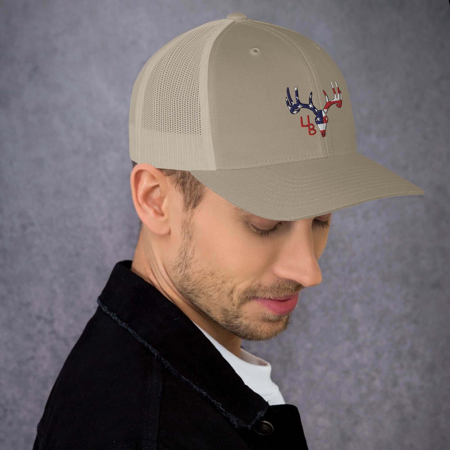 4B Americana Deer Trucker Hat This six-panel trucker cap with a mesh back will be a comfy and classic choice for a perfect day in the sun. • 60% cotton, 40% polyester • Mid-profile cap with a low-profile embroidery area • Structured, six-panel cap • 3.5″