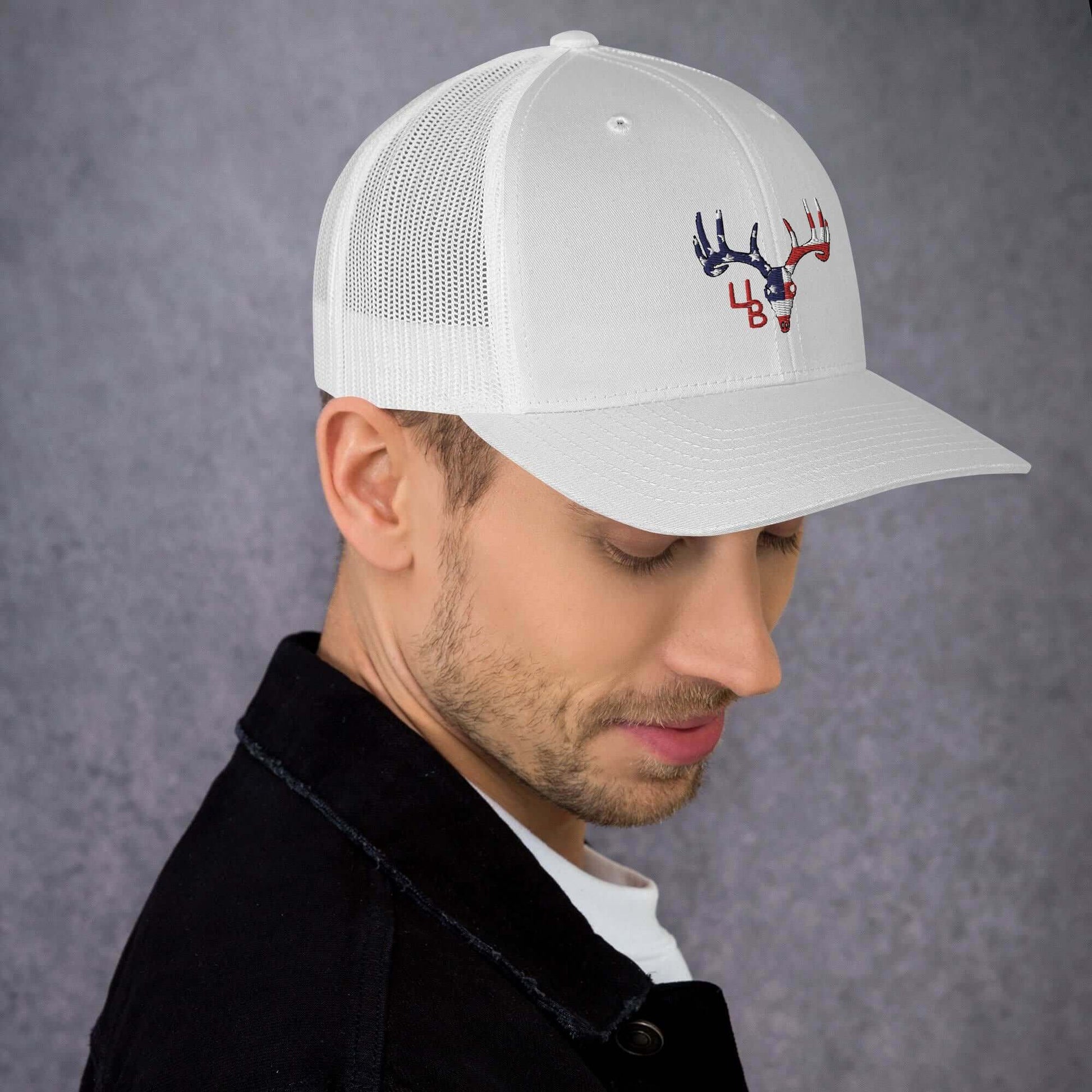 4B Americana Deer Trucker Hat This six-panel trucker cap with a mesh back will be a comfy and classic choice for a perfect day in the sun. • 60% cotton, 40% polyester • Mid-profile cap with a low-profile embroidery area • Structured, six-panel cap • 3.5″